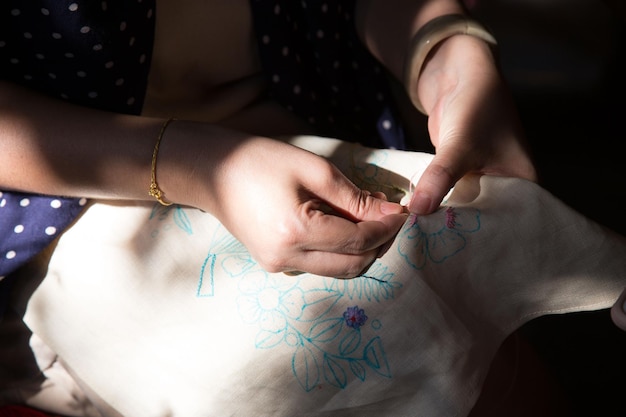 Artisan hands stitching detailed pattern